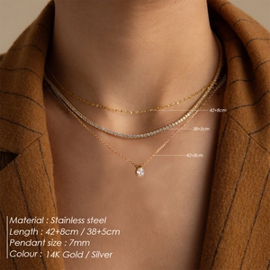 Layered 14K gold stainless steel necklace set with pear shape zircon on striped blazer