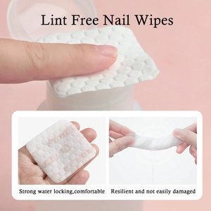 Close-up of lint-free nail wipes with honeycomb texture showing high water absorption