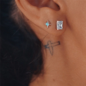 Close-up of S925 silver octagonal opal and emerald-cut zircon studs on ear model