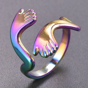 Macro shot of colorful rainbow hug hand open ring with polished stainless steel texture