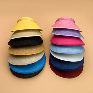 Detailed top view of assorted colorful woven sun visors with textured straw pattern