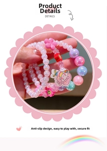Detail view of children acrylic beaded bracelets set with floral and cartoon charms