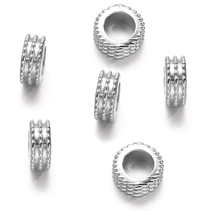 Macro detail of silver CCB plastic spacer beads with granular texture for DIY jewelry