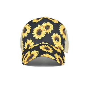 Black trucker hat with yellow sunflower print and breathable mesh back for ponytail