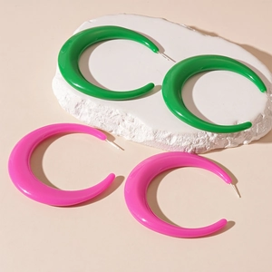 Exaggerated oversized acrylic hoop earrings in vibrant green and bright pink colors