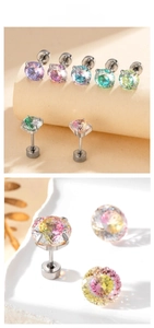 Macro shot of 7-color gradient round cut zircon studs with screw back on stainless steel