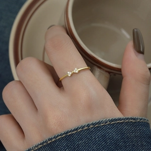 Elegant S925 sterling silver bow ring with zircon, worn by model in a warm setting