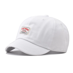 Detailed close-up of white cotton canvas baseball cap with vintage BRO MAC woven patch