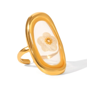 Macro shot of gold stainless steel open ring with shell flower resin centerpiece