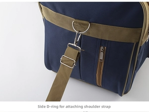Detail of metal D-ring and detachable shoulder strap on large travel bag