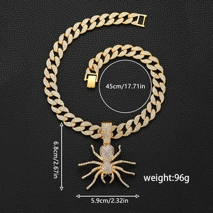 Detailed view of iced out spider pendant on gold Cuban chain with size measurements
