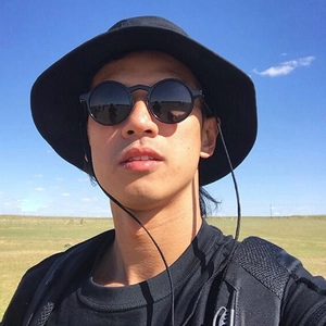 Detail of round retro sunglasses with rice nail studs and wide brim outdoor sun hat
