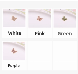 Macro view of butterfly pendant charms in white, pink, green, and purple cubic zirconia