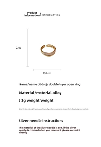 Detail view of gold double-layer open ring with white enamel drip and size measurements
