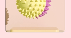 Detailed close-up of textured TPR pet toy ball with yellow and purple massage spikes