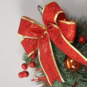 Christmas teardrop wreath with red glitter bow, green pine needles and orange ornaments