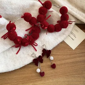 Winter festive red velvet bow earrings with rhinestones and plush pom-poms for women
