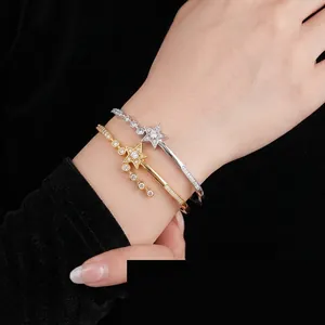 Adjustable gold and silver shooting star bangle bracelets with cubic zirconia inlays