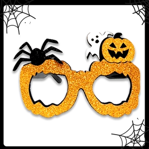 Détail de lunettes citrouille Halloween avec paillettes orange araignées et fantômes