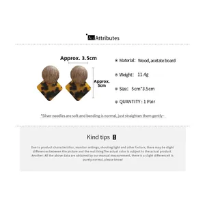Detailed view of geometric earrings made of wood and acetate with 925 silver needles