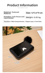 Black patent leather wallet with white butterfly charm and black fluffy pompom detail