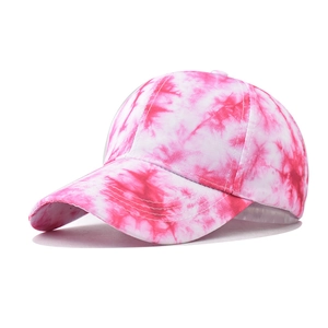 Detail view of cotton baseball cap featuring red and white tie-dye starry gradient pattern