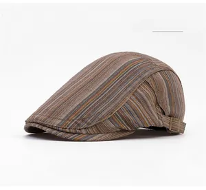 Detail of the adjustable metal buckle and textured striped fabric on a brown newsboy cap