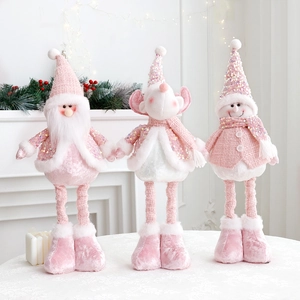 Pink Christmas plush doll collection featuring Santa snowman and reindeer on a table
