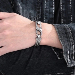 Detail of vintage braided steel chain bracelet with horseshoe buckle on a wrist