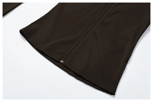 Detailed view of the smooth zipper and fine stitching on a dark brown yoga jacket