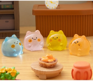 Macro shot of four colorful luminous cat figurines for DIY miniature landscape decor