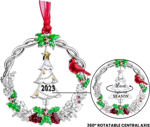 Close-up of rotatable Christmas ornament with silver finish and enamel detailing
