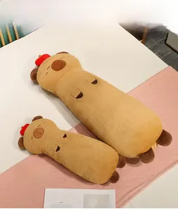 Detail of long capybara plush pillows in 115cm and 75cm sizes on a cozy bed