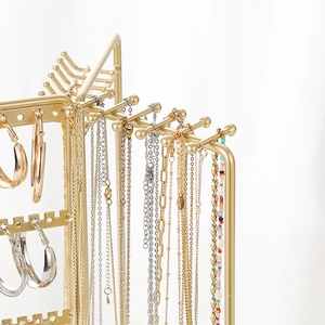 Rotating metal jewelry stand with wooden base for necklace and earring storage