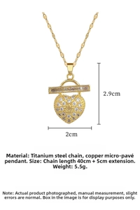 Macro view of gold heart necklace with full pave zircon and star relief detail