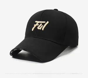 Detail of black baseball cap featuring 3D gold Ful embroidery and white Sport lettering