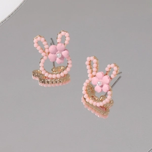 Detailed macro view of pink rabbit studs with gold alloy frame and pearl accents