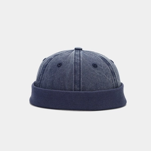 Detail showing the retro washed denim texture and ribbed edge of the dark blue docker hat