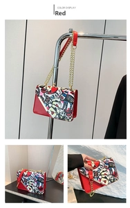 Detail of red graffiti chain bag with heart and poker patterns on leather flap