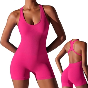 Women's hot pink seamless one-piece yoga bodysuit with racerback cutout design