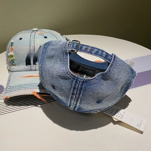 Detail of vintage denim baseball caps with embroidery and adjustable metal buckle strap