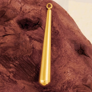 Macro view of a gold teardrop pendant on a dark wood texture for DIY jewelry making