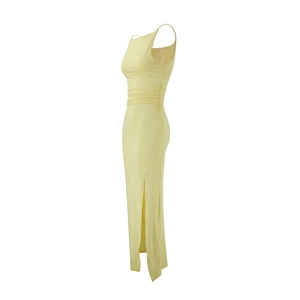 Side view of light yellow maxi dress featuring waist ruching and a high side slit detail