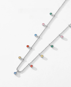 Macro detail of S925 sterling silver chain with multi-color cubic zirconia pendants