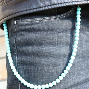 Sky blue turquoise beaded wallet chain accessory shown on black denim trousers