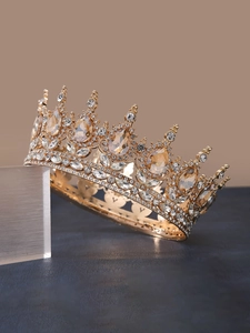 Close-up of luxury gold crown featuring champagne rhinestones and intricate metalwork