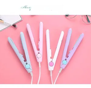 Mini hair straighteners in grey pink white and purple colors on a pink background