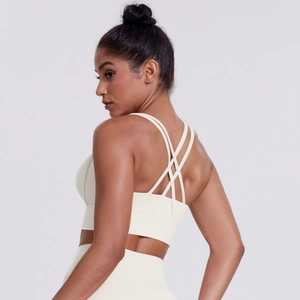 Detail view of the crisscross multi-strap back design on a beige sports bra vest