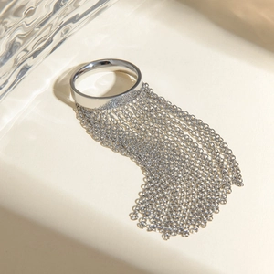 Macro shot of silver stainless steel ring featuring delicate chain fringe with water ripple light