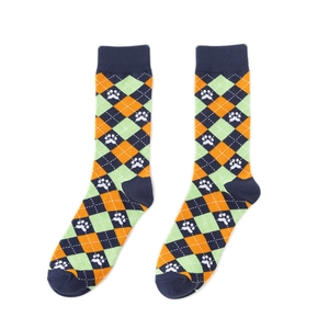Detailed view of argyle pattern socks with cute white pet paw prints on navy and orange fabric
